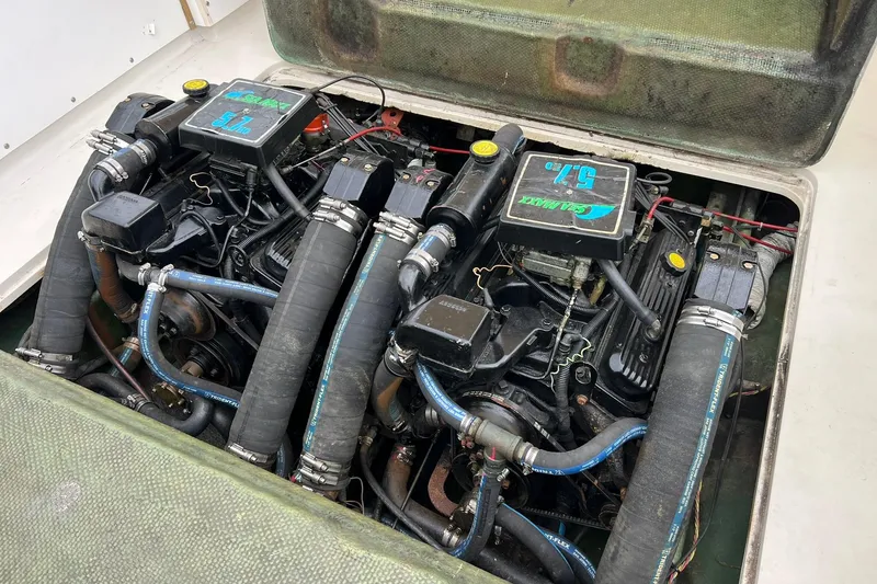 Slide: The Image of Twin engines in a 1970 Bertram 25 Moppie boat, showcasing detailed mechanical components. - 38