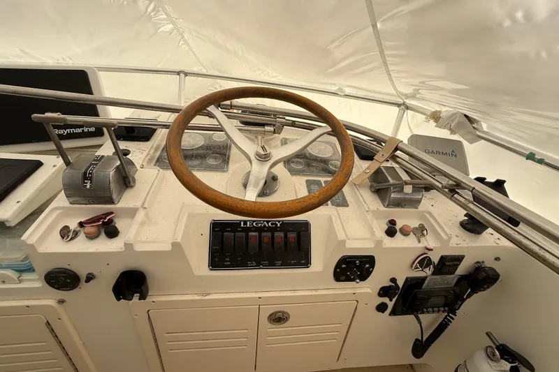Slide: The Image of Cockpit of 1996 Legacy Yachts 40 with steering wheel and navigation equipment. - 26