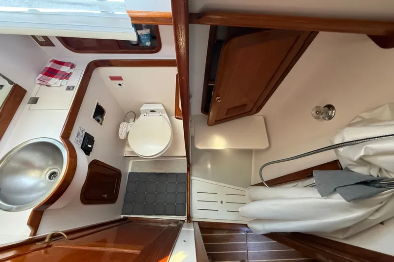 Slide: The Image of 1996 Legacy Yachts 40 bathroom interior with sink, toilet, and wooden cabinetry. - 29