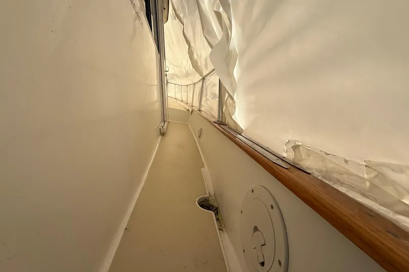 Slide: The Image of Narrow walkway on a 1996 Legacy Yachts 40, featuring white canvas cover. - 25
