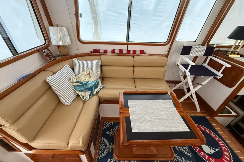 Slide: The Image of Interior of 1996 Legacy Yachts 40 with cozy seating and nautical decor. - 4