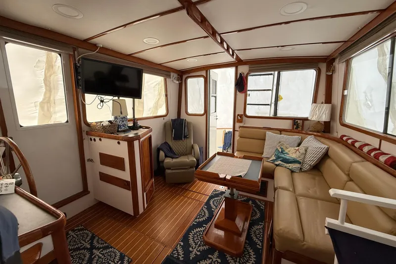 Slide: The Image of Interior of 1996 Legacy Yachts 40, featuring cozy seating and nautical decor. - 3