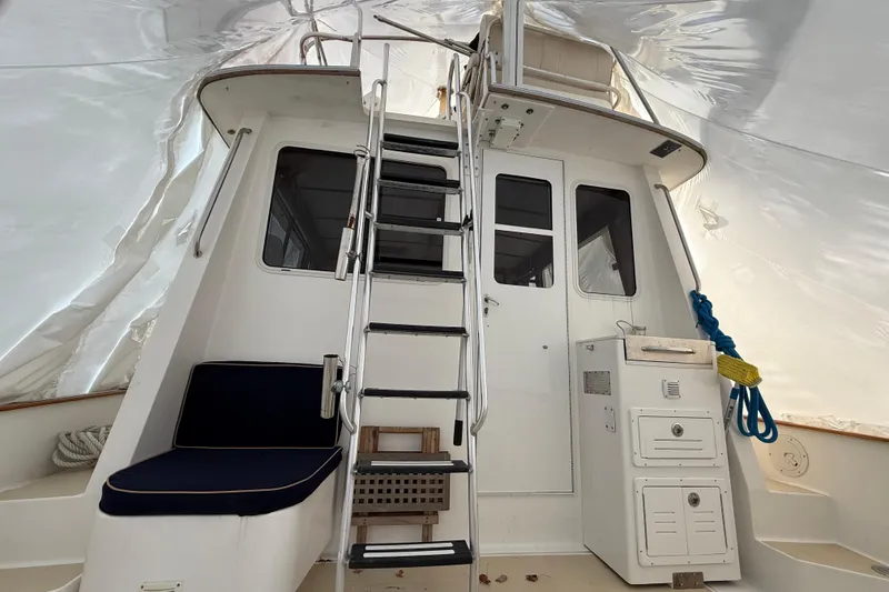 Slide: The Image of Interior view of 1996 Legacy Yachts 40, featuring ladder and seating area. - 23