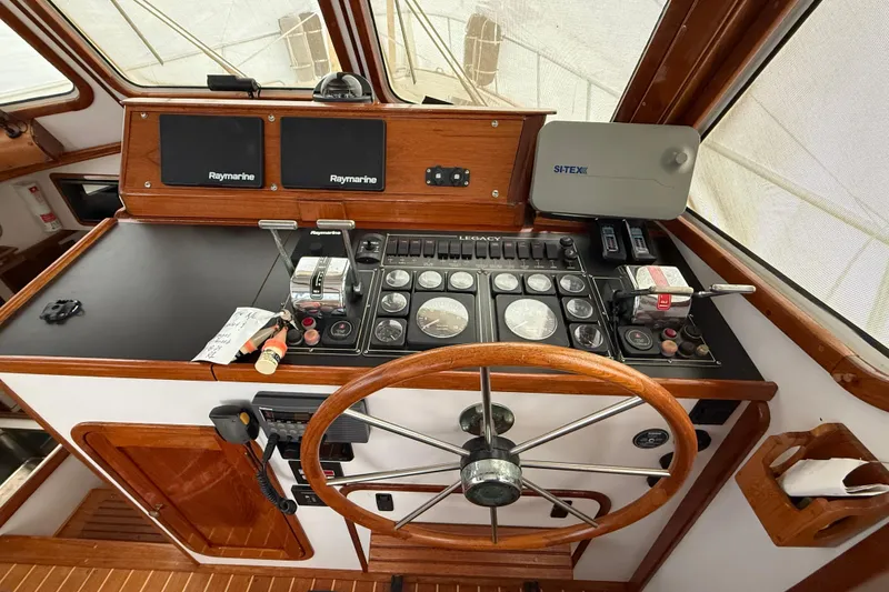 Slide: The Image of Helm of 1996 Legacy Yachts 40 with navigation instruments and wooden steering wheel. - 8