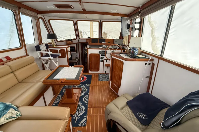 Slide: The Image of Interior of 1996 Legacy Yachts 40, featuring cozy seating and wooden accents. - 2