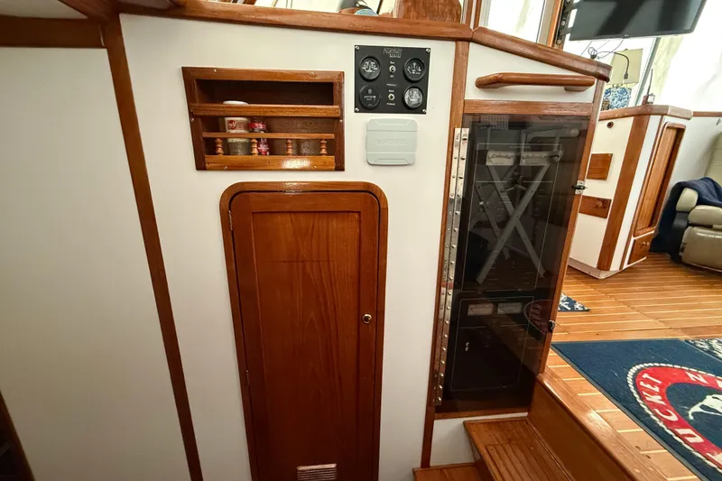 Slide: The Image of Interior of 1996 Legacy Yachts 40, featuring wooden cabinetry and control panel. - 14