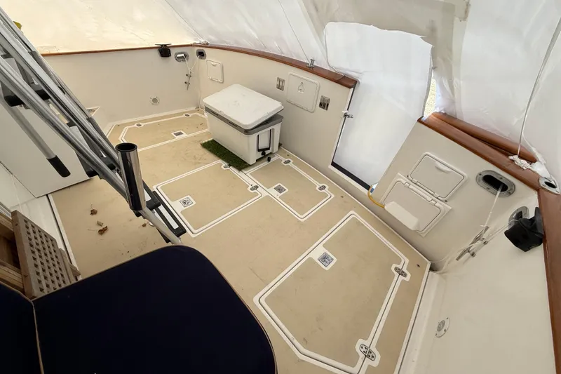 Slide: The Image of 1996 Legacy Yachts 40 cockpit with storage compartments and seating under protective cover. - 20