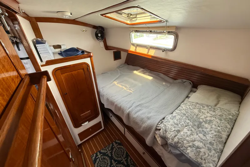 Slide: The Image of Cozy cabin interior of 1996 Legacy Yachts 40 with wooden finishes and comfortable bedding. - 27