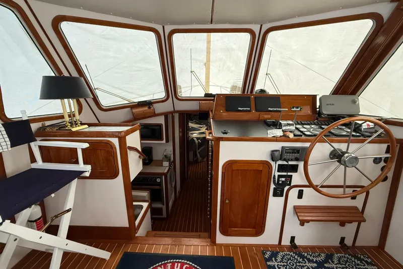 Slide: The Image of Interior of 1996 Legacy Yachts 40, featuring helm station and wooden accents. - 7