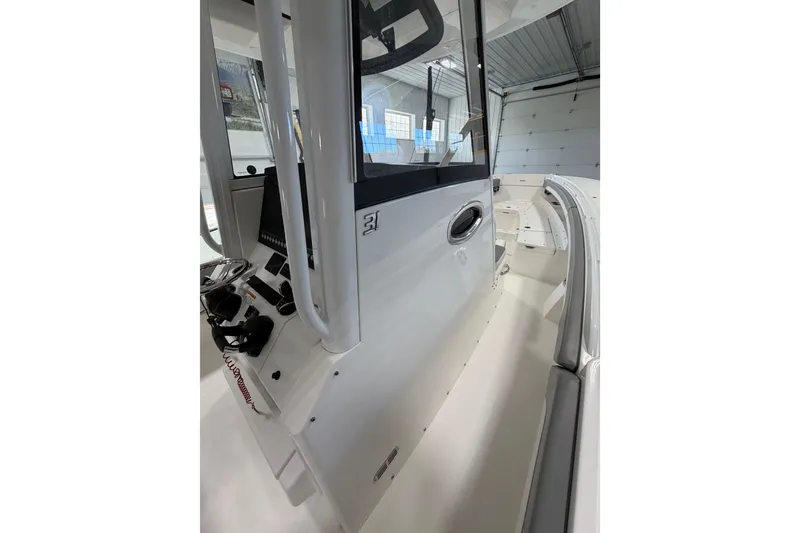 Slide: The Image of 2023 Regulator 31 boat interior with steering console and seating area. - 10
