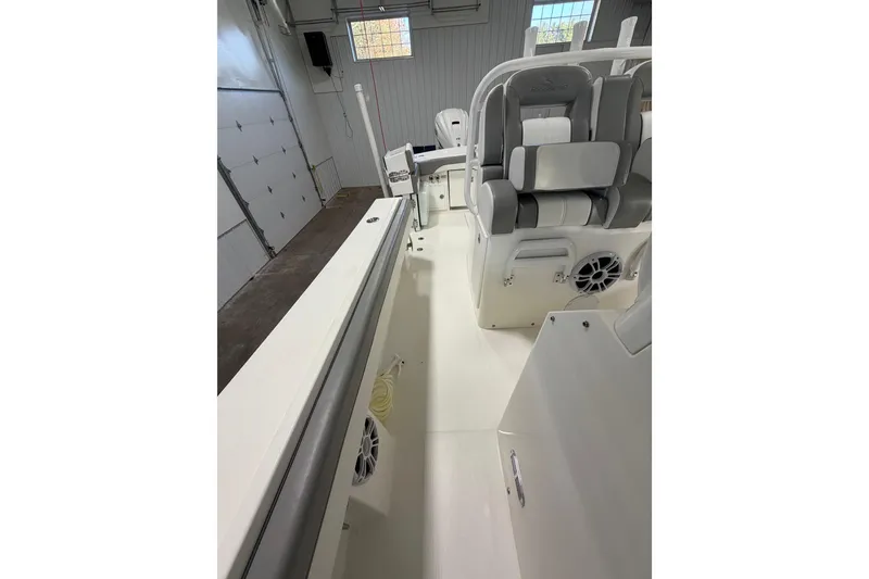 Slide: The Image of 2023 Regulator 31 boat interior with seating and speakers in a garage setting. - 12