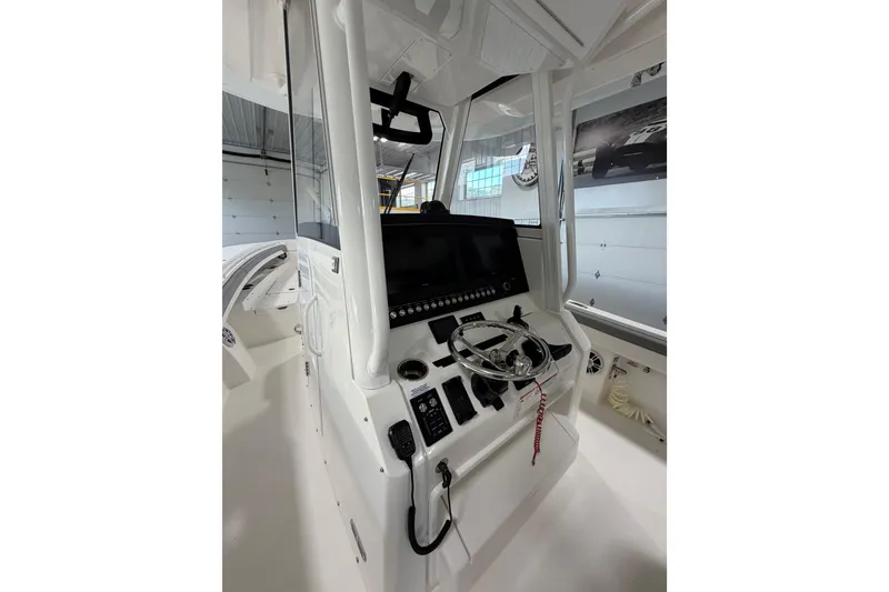 Slide: The Image of 2023 Regulator 31 boat cockpit with steering wheel and control panel. - 17