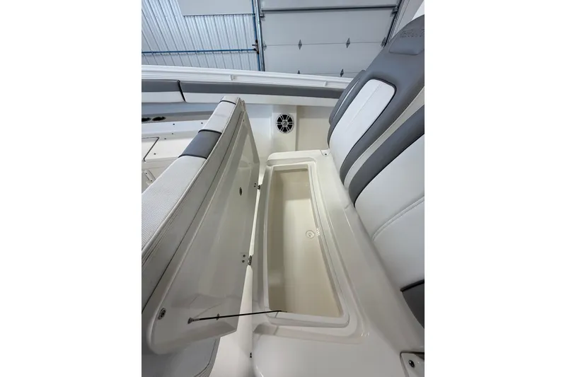 Slide: The Image of 2023 Regulator 31 boat interior storage compartment with cushioned seating. - 22