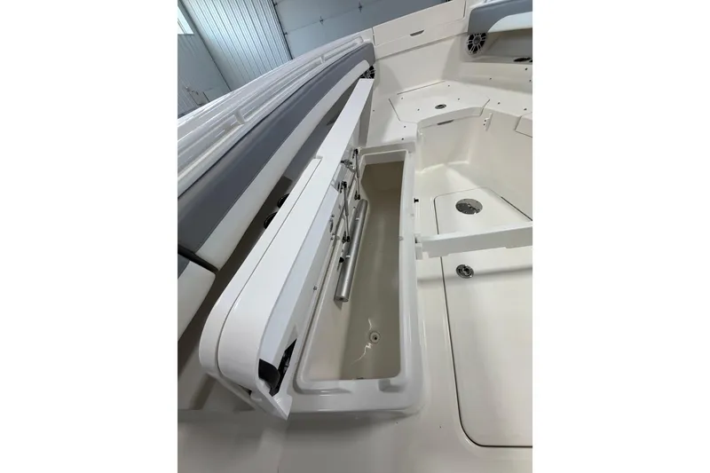 Slide: The Image of 2023 Regulator 31 boat interior with open storage compartment, showcasing sleek design and functionality. - 24
