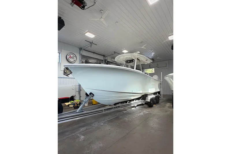 Slide: The Image of 2023 Regulator 31 boat in a garage on a trailer. - 3