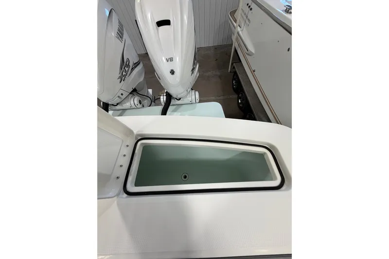 Slide: The Image of 2023 Regulator 31 boat with open storage compartment and dual Yamaha outboard engines. - 33