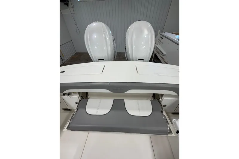 Slide: The Image of 2023 Regulator 31 boat with dual outboard engines in a garage setting. - 35