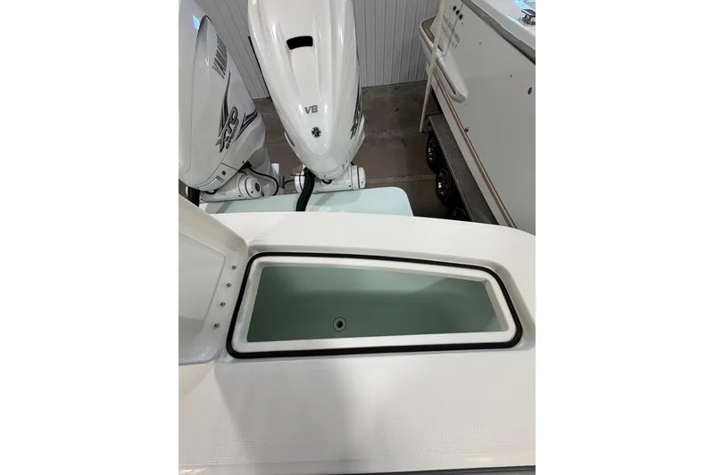 Slide: The Image of 2023 Regulator 31 boat with open storage compartment and twin outboard engines. - 37