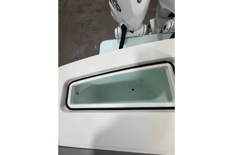 Slide: The Image of 2023 Regulator 31 boat livewell with white interior and visible outboard motors. - 38