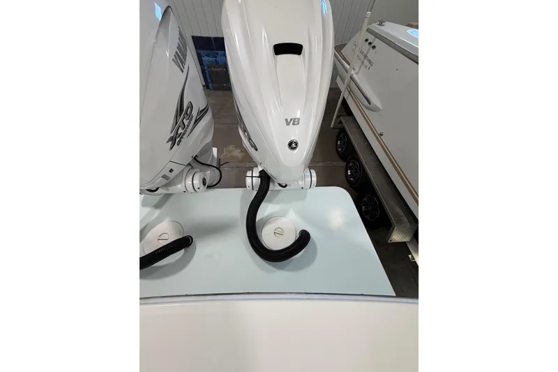 Slide: The Image of 2023 Regulator 31 boat with dual Yamaha outboard engines in a showroom. - 39