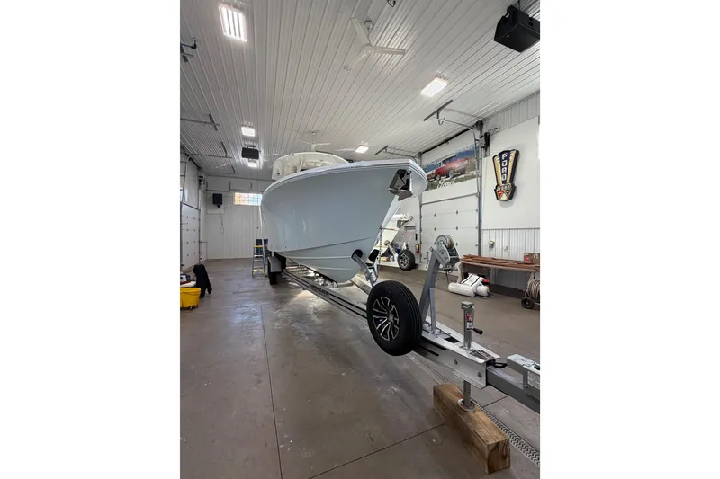 Slide: The Image of 2023 Regulator 31 boat on trailer inside a spacious garage. - 4