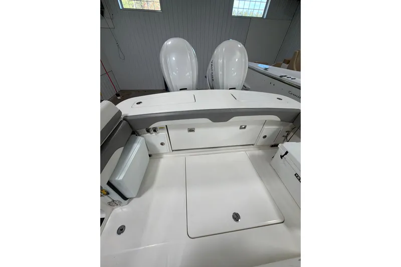 Slide: The Image of 2023 Regulator 31 boat interior with dual engines, featuring spacious deck and storage compartments. - 40