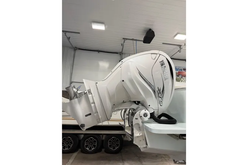 Slide: The Image of 2023 Regulator 31 boat with Yamaha outboard motor in a garage setting. - 41