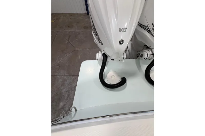 Slide: The Image of 2023 Regulator 31 boat with dual V8 engines in a garage setting. - 42