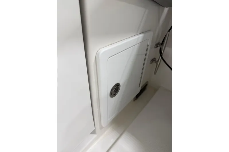 Slide: The Image of 2023 Regulator 31 boat storage compartment with secure latch. - 43