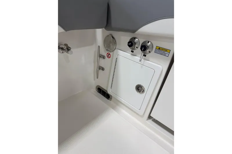 Slide: The Image of Interior view of a 2023 Regulator 31 boat, featuring control panel and storage compartment. - 44