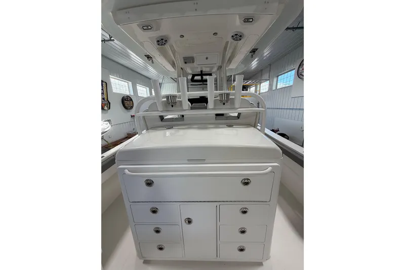 Slide: The Image of 2023 Regulator 31 boat interior with storage compartments and rod holders. - 6