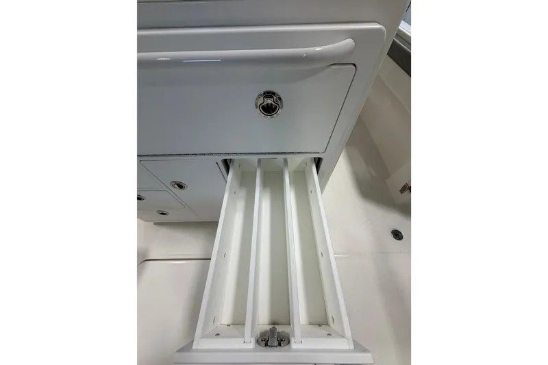 Slide: The Image of Open storage compartment on 2023 Regulator 31 boat, showcasing sleek design and functionality. - 8