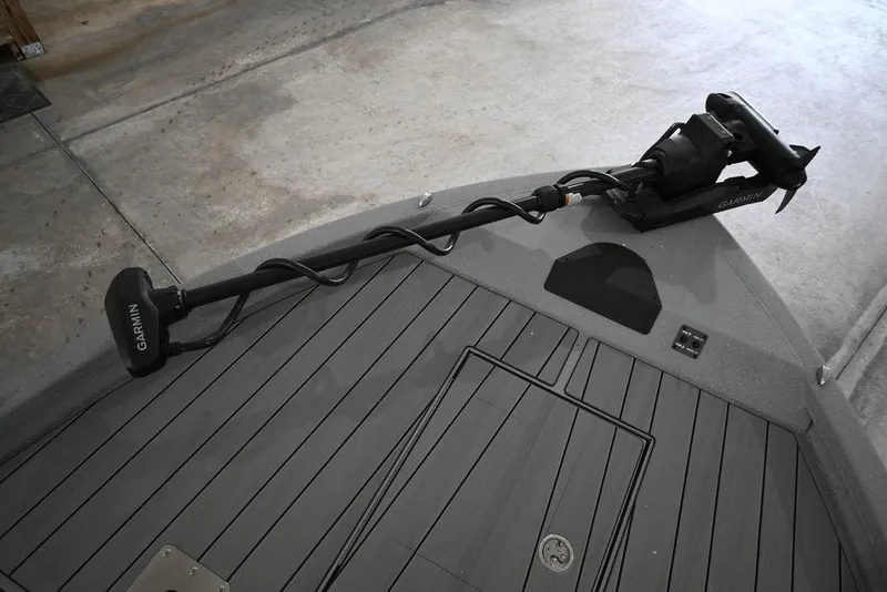 Slide: The Image of 2026 Vexus ACX 2210 boat deck with Garmin trolling motor in a garage setting. - 10