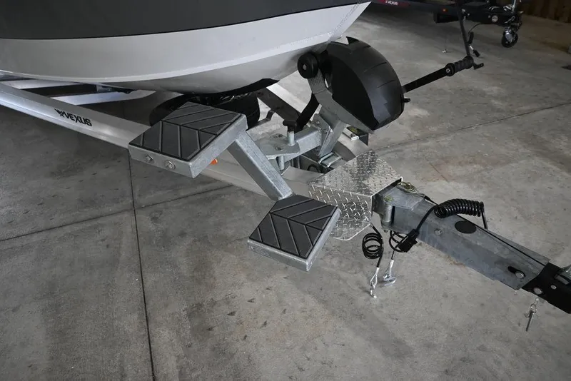 Slide: The Image of Trailer hitch of 2026 Vexus ACX 2210 boat with sturdy metal steps. - 11