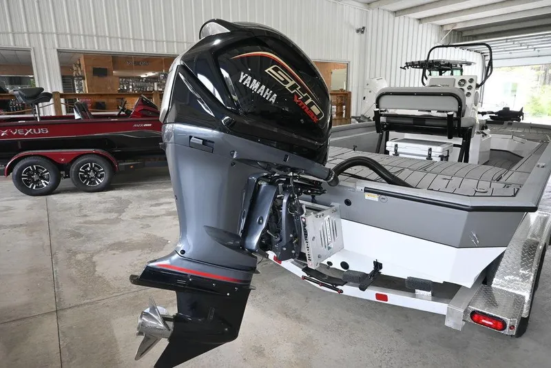 Slide: The Image of 2026 Vexus ACX 2210 boat with Yamaha engine in a garage setting. - 5