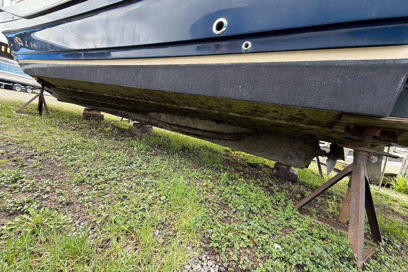 Slide: The Image of 2014 Ranger Tugs R-27 boat deck with seating and storage, parked outdoors. - 15