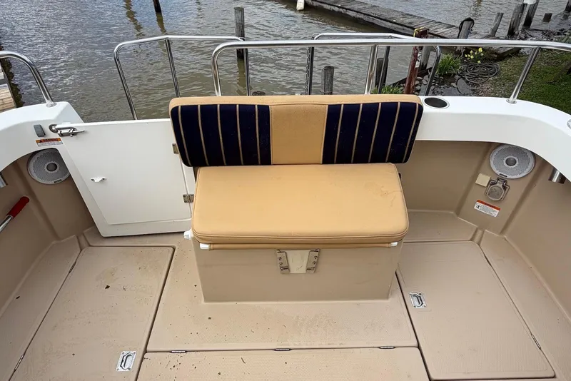 Slide: The Image of Interior of a 2014 Ranger Tugs R-27 boat, featuring wood finishes and a cozy cabin layout. - 17