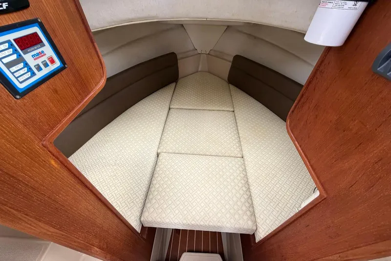 Slide: The Image of Interior of a 2014 Ranger Tugs R-27 boat with wooden table and seating area. - 23