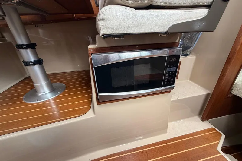 Slide: The Image of Interior of 2014 Ranger Tugs R-27 boat with wooden flooring and storage space. - 26