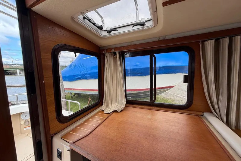 Slide: The Image of Interior view of 2014 Ranger Tugs R-27 boat cockpit with steering wheel and navigation equipment. - 28