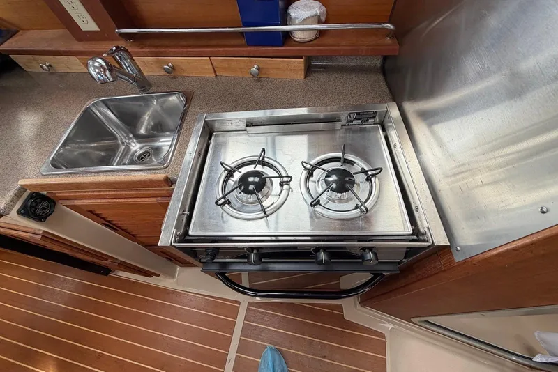 Slide: The Image of Interior of a 2014 Ranger Tugs R-27 boat featuring a compact kitchen area. - 31