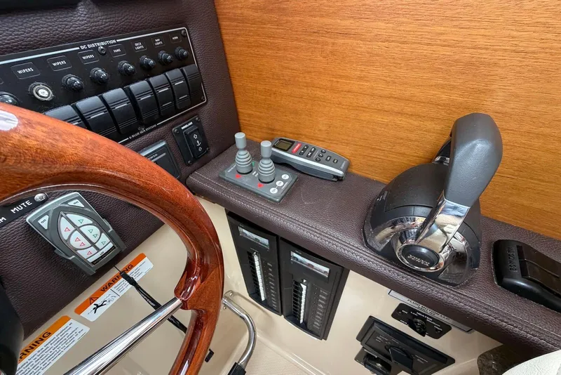 Slide: The Image of Interior of 2014 Ranger Tugs R-27 boat with control panel and wooden finish. - 36