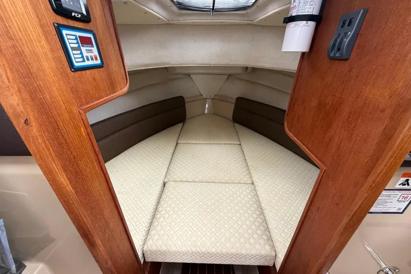 Slide: The Image of Interior of 2014 Ranger Tugs R-27 with seating and wooden table. - 38