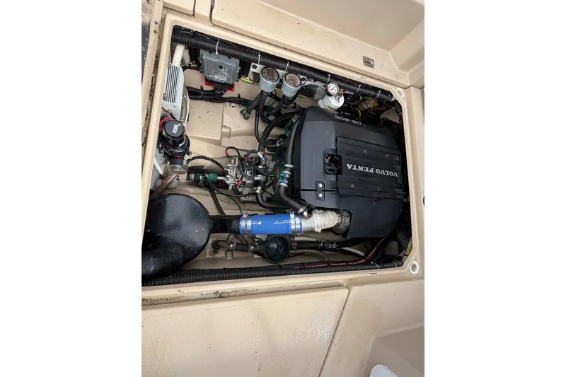 Slide: The Image of Battery compartment of a 2014 Ranger Tugs R-27 with visible wiring and connections. - 40