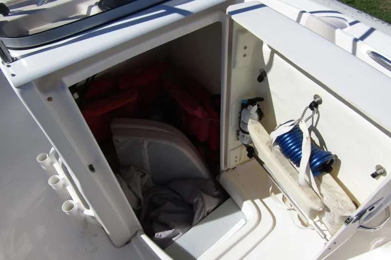 Slide: The Image of 2019 Robalo R180 Center Console storage compartment with safety gear and equipment. - 10
