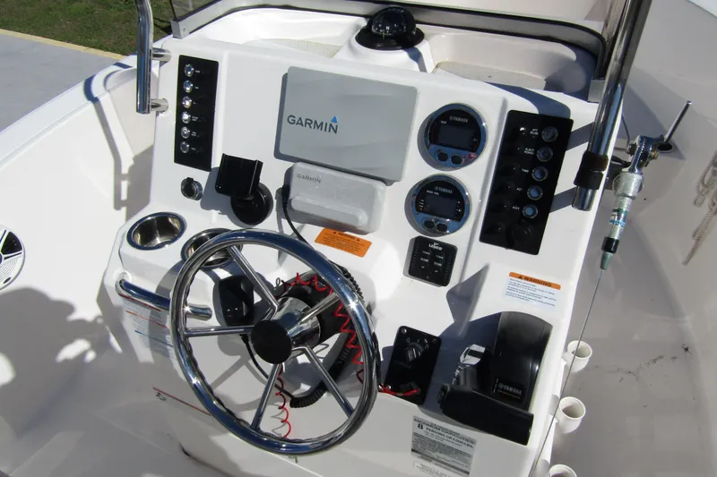 Slide: The Image of 2019 Robalo R180 Center Console dashboard with Garmin navigation system and steering wheel. - 12