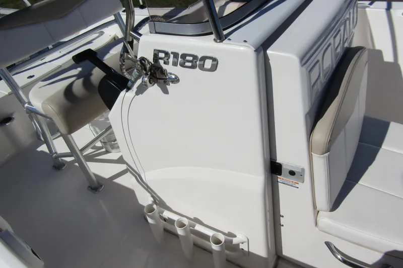 Slide: The Image of 2019 Robalo R180 Center Console boat interior with seating and rod holders. - 13