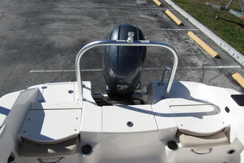 Slide: The Image of 2019 Robalo R180 Center Console boat with outboard motor in parking lot. - 14