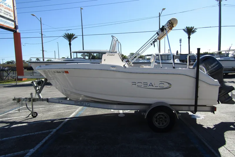Slide: The Image of 2019 Robalo R180 Center Console boat on trailer in parking lot. - 3