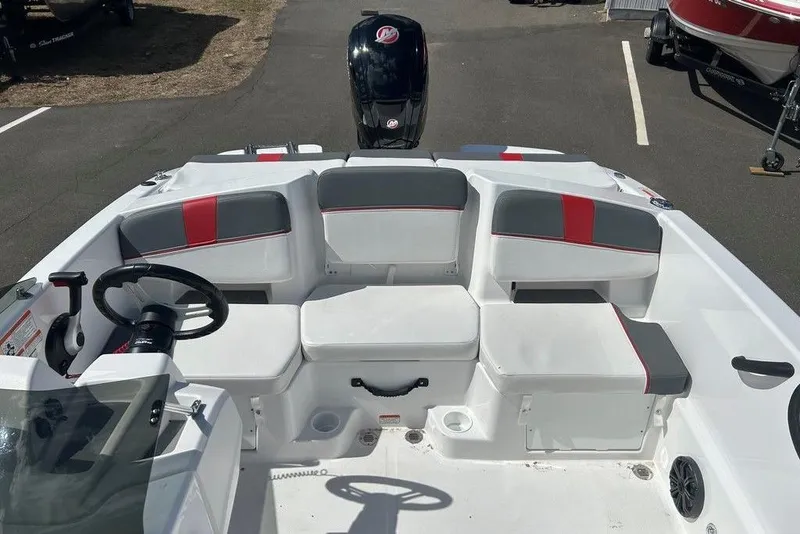 Slide: The Image of 2025 Tahoe T18 boat interior with seating and steering wheel, featuring red and gray accents. - 10